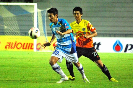 Pattaya United midfielder Kritsana Taiwan (left) shields the ball from FC Pichit’s Ekkarak Thongkrit at a rain soaked Physical Education Stadium pitch in Chonburi, Sunday, Sept. 11. (Photo /Ariyawat Nuamsawat)